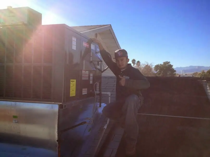 HVAC technician performing AC Tune-Up on a rooftop unit in Fort Myers Shores